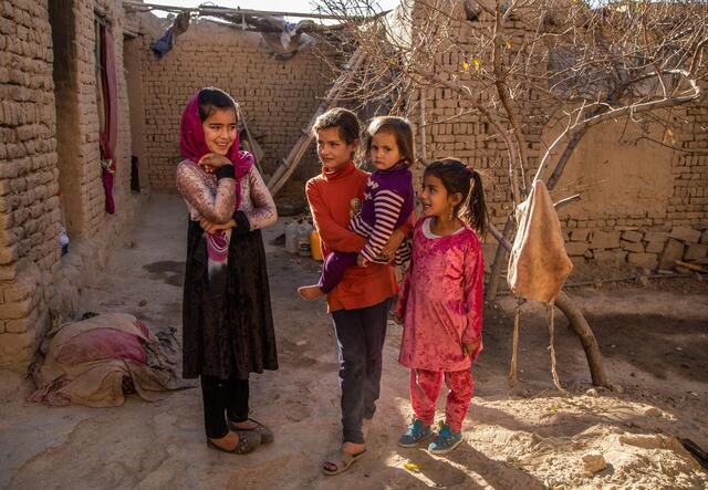 Children play outside their temporary home in Kabul, Afghanistan